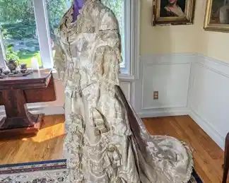 22)  ca 1870's  - 1880's Brocade Reception Gown with lace and beads.  Bodice -  boned and in very good condition except for underarm damage.   Skirt - overall in pretty good condition but has some problems.  There are some stains, tears, and the waist band is tearing from the skirt due to the  weight of the skirt.  The skirt is very heavy!! There is beautiful beaded fringe under the lace of the skirt.  A small amount of beadwork fringe is missing at the hem.  Dress appears to have been a light lavender color and has faded.  Dress needs some repair but is still a magnificent  display piece.   Measures:  Bodice:  shoulder to shoulder - 15",  Bust 34",  Waist 30", Length 22".  Skirt:  waist 24",  Length 40",  Length with train 72".    $2200.00