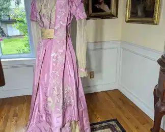 27.)  ca 1900 Parisian Pink Silk and Lace Hand Embroidered Evening Gown.  Beautiful hand done embroidery.  Outer silk and embroidery in very good condition.  1 small water stain on bodice.  Very light underarm staining.  Hook and eye  closure in back.  Inner silks are shattering.  Dress labeled.  Label is difficult to read but I think is says Mme. Margane, Paris.   Measures:  shoulder to shoulder 15",   Bust - 28",  Waist 22",  Length 54".    $750.00