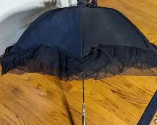 4.)  Black cotton and net Parasol with Brass and Mother  of Pearl handle.  Handle is loose.  Very beautiful handle.  $178.00