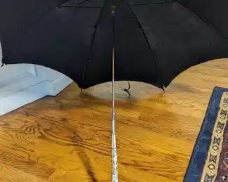 3.)  Black Parasol/Umbrella with Brass and Mother of earl Handle.  Monogrammed FMS.  1 spoke broken.  Pin holes in cover.   Stunning handle.  $195.00