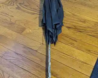 2.)  Black Parasol/Umbrella with Brass and Mother of Pearl Handle.  Spokes are in good condition.  Needs recovering. $165.00