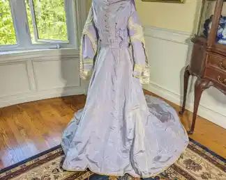 29.)  ca 1868 Lavender Bridal/Wedding gown with history. Valencieness Lace and fine thread Cluny Lace.  Dress has family note with it stating it is a wedding gown from 1868.   Drop shoulders, decorative braiding.  Original belt.  There are a few pin holes in  the skirt and some discoloration at underarms.  Occasional small stain.  Some dirt on train.  There are 4 missing buttons.  Some slight discoloration. Measures:  shoulder to shoulder - 17 ", Bust - 32", Waist 24", Length - 55",  Length with train - 80".   $725.00