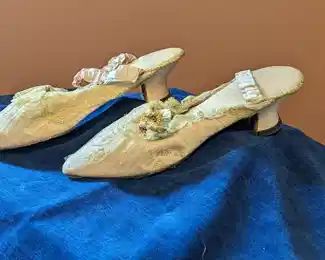 2.)  Pink Satin and Lace Shoes with ribbon flowers.  Shoes have elastic bands at the back.  The elastic bands are stretched out.  Each heal has a screw in it so I believe the heal has been replaced.  Leather soles.  Measures:           10 1/2" long  x 23 /4" wide.  $152.00