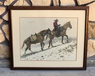Signed 1990 limited edition print of a mounted cowboy leading a pack horse up a ridge, #505/1250, entitled "Ridin' The Rims" by Wyoming artist James Bama. Gallery framed with Certificate of Authenticity. 15" x 19" image size in a 23" x 28" frame.