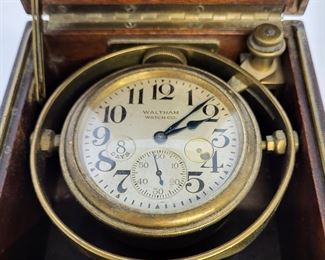 RARE Antique WALTHAM Marine Chronometer Clock. Antique 8 day clock with wind indicator that was used on board a ship. The clock is supported in a walnut case on gimbals that allow it to remain steady or level when the base tips. Case measures 5" x 5" x 5". Very fine working condition.
