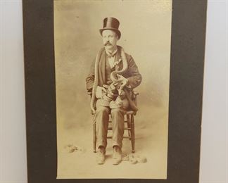 Cabinet photograph taken by John Calvin Brewster in the late 1800s of a snake charmer circus performer in Ventura, California. 7 1/2" x 5" image, 10" x 8" card