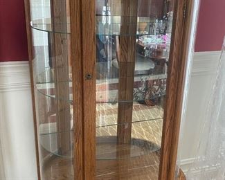 Amish-made oak curio cabinet with curved glass