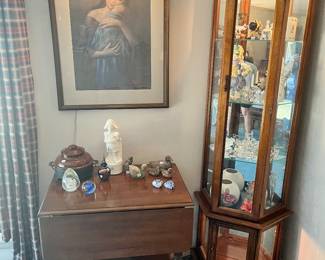 Tall, narrow, lighted, curio cabinet, tea cart, artwork, assortment of Crystal figures