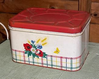Vintage Metal Bread Box Flower Design With Red Top Filled With Linens
