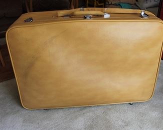 beige letter suitcase