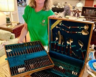 Dawn showing off the Huge Thai bronze flatware set. Party time!