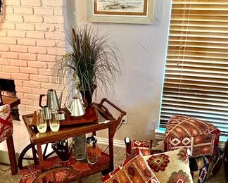 Bar or tea cart. Lots of Kilim pillows and foot stools. 