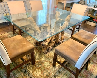 Grapevine base dining table with glass top and 6 chairs. $1,750