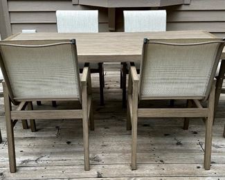 Beautiful and Contemporary Outdoor Dining Table and 6 Sling Outdoor Dining Chairs from"The Great Escape" only 2 years old...