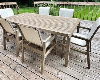 Beautiful and Contemporary Outdoor Dining Table and 6 Sling Outdoor Dining Chairs from"The Great Escape" only 2 years old...