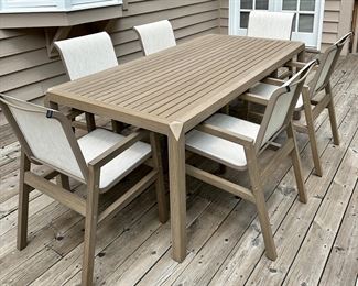 Beautiful and Contemporary Outdoor Dining Table and 6 Sling Outdoor Dining Chairs from"The Great Escape" only 2 years old...