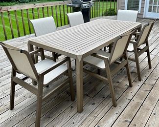 Beautiful and Contemporary Outdoor Dining Table and 6 Sling Outdoor Dining Chairs from"The Great Escape" only 2 years old...