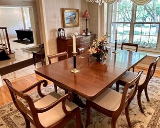 Duncan Phyfe 1930's Dining Table with 3 Leaves and Custom pads.  Total of 6 Dining Chairs with One Armed Chair. The Table has 2 Pedestals.  60" L x 40" W with 3 10" Leaves. 