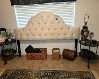 King tufted headboard, round wood/iron side tables. Window valance