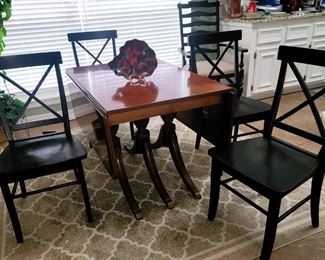 Drop leaf, 3-pedestal, gateleg table with 3 leaves. 4 black wood dining chairs