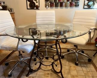 Glass table with four white rolling chairs