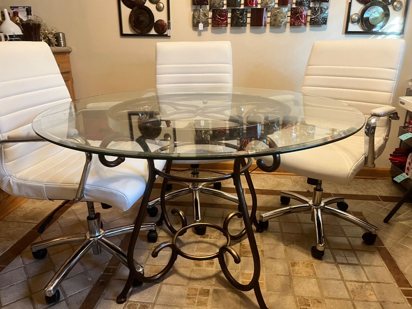 Glass table with four white rolling chairs