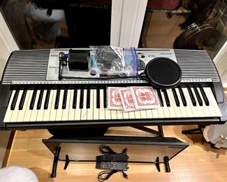 Keyboard, banjo, electric guitar, bongo drums, tv, flute, multiple speaker sets