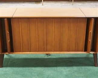 1004	MIDCENTURY MODERN WALNUT STEREO CONSOLE W/UNUSUAL CANTILEVER DOORS FOR SPEAKERS ZENITH, NO TURNTABLE, APPROXIMATELY 54 IN X 17 IN X 25 IN HIGH
