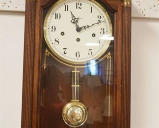 1153	HOWARD MILLER WALL CLOCK IN CHERRY CASE, APPROXIMATELY 7 IN X 13 IN X 25 IN HIGH
