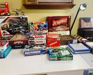 tables filled with wooden games and new in boxes games--can you see the like new large drafting table?
