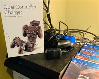 PlayStation 4 with controllers and four games