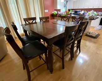 Large dining table with 8 black chairs