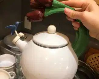 Cute teapot with tulips and hummingbird
