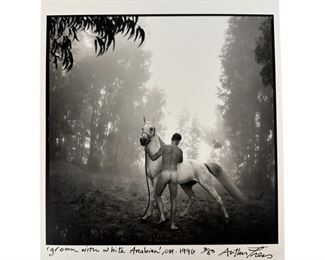 Arthur Tress (American, born 1940). A limited edition black and white photographic art print. Titled "Groom With White Arabian, CA.". A figural work modeled in an idyllic forest landscape depicting a nude male figure, seen from behind, with a white horse. Signed, numbered 3/50 and dated 1996 at bottom, with additional information and notes by artist on verso. Unframed. 