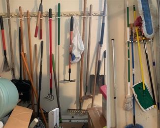 Garage is packed with lawn and yard tools as well as household tools, tables full of $1-3-5 items