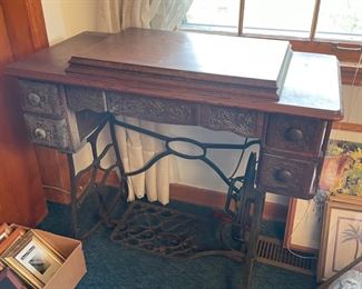 #25		"Antique sewing table w/ wood and wrought iron. 35""x17.5""x31.5"". Sewing machine, Minnesota ""A""."	($ 125.00)