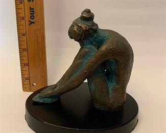 Solid Bronze of nude on black base.  
