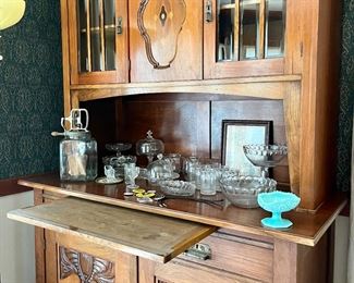 Art Nouveau sideboard and hutch with pullout cutting board.  Pressed glass coin dot bowls, plates, glasses.  Fostoria Wingate aqua milk glass candy dish