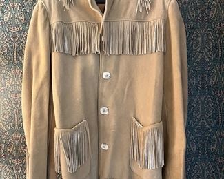 Mens handmade doe skin jacket with hand cut fringe and bone buttons.