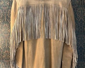 Mens handmade doe skin jacket with hand cut fringe and bone buttons.  1940’s
