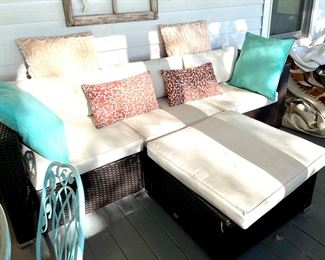 Outdoor sofa with ottoman and cushions