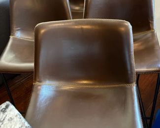 4 brown faux leather barstools with stitching detail