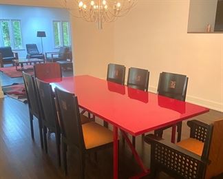 Roche Bobois red lacquer dining table shown with eight Roche Bobois chairs
