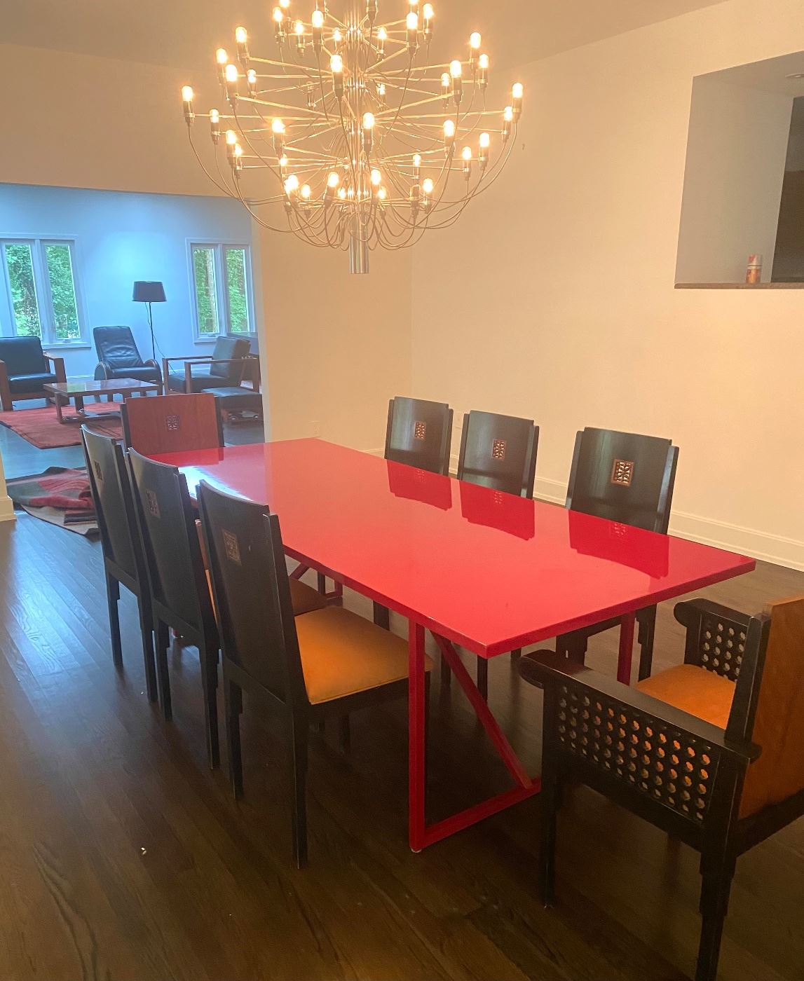 Roche Bobois red lacquer dining table shown with eight Roche Bobois chairs