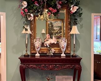 HUGE custom silk floral arrangement, candlestick lamps, brass deer floor figures, HUGE gold beveled glass wall mirror, tall and hand carved display table