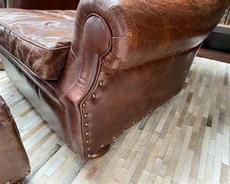Now $2240.00 - Was $3,200.00 Pair Restoration Hardware “Churchill” leather chairs & ottomans  Chairs: 36"h x 38"w x 40"d                                             Ottomans: 16"h x 28"w x 23"d  *tear to one arm