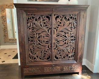 Now $595.00 - Was $850.00 British Colonial-style carved wood cabinet       65"h x 61"w x 26"d