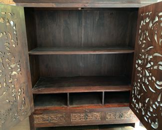 Now $595.00 - Was $850.00 British Colonial-style carved wood cabinet       65"h x 61"w x 26"d