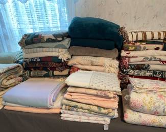 Stacks of very clean, great condition blankets, throws, quilts and pillows. 