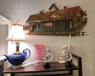 Fantastic light lamp made out of an actual Aladdin brand MCM ceramic oil lamp… the irony here is very real. Super cool mid century modern wall mount metal sculpture of a train station, and some amazing signed Murano glass birds